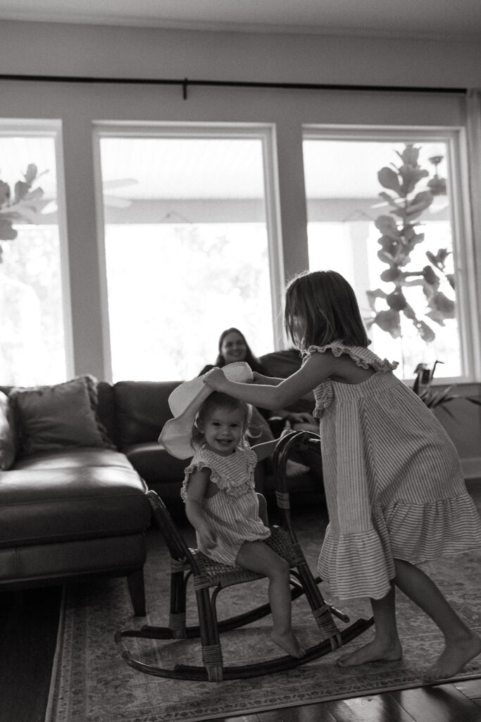 sisters playing together in their living room.