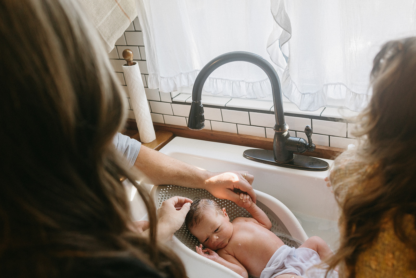 jacksonville fl family giving baby a bath in the sink