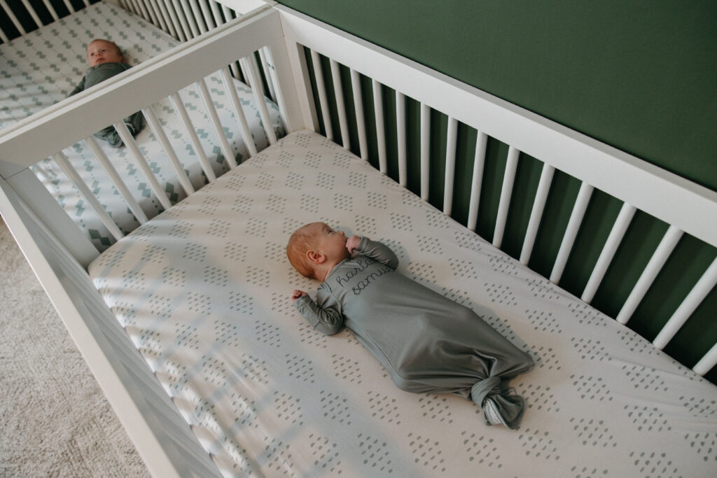 newborn twins relaxing in their cribs.