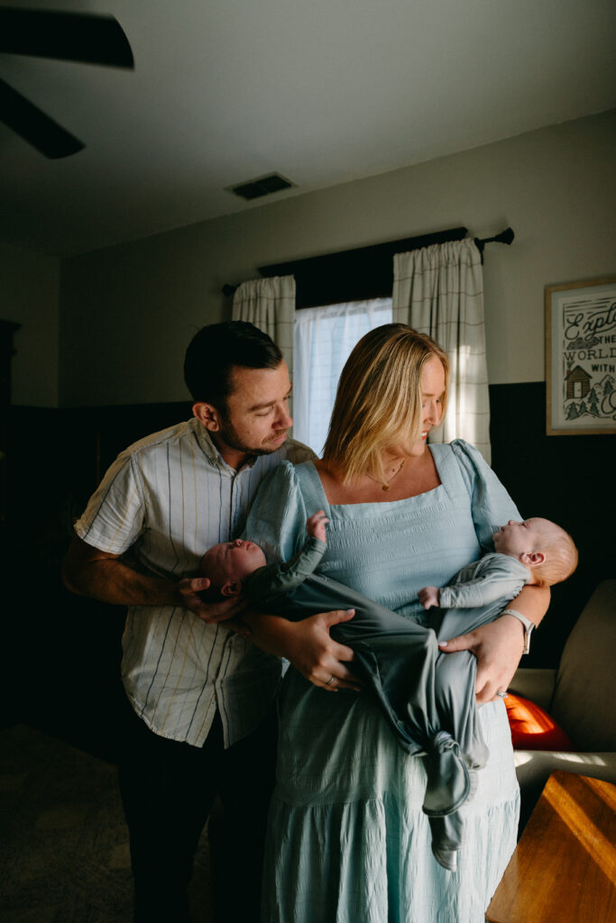 jacksonville fl parents holding and admiring their new baby twin boys