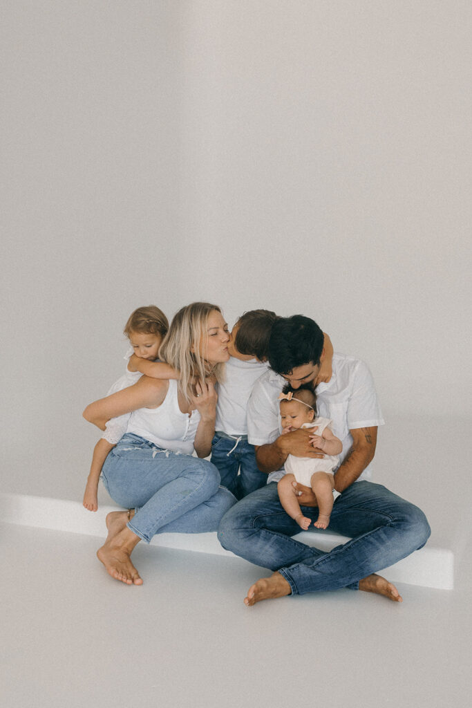 family sitting down cuddling at a jacksonville studio