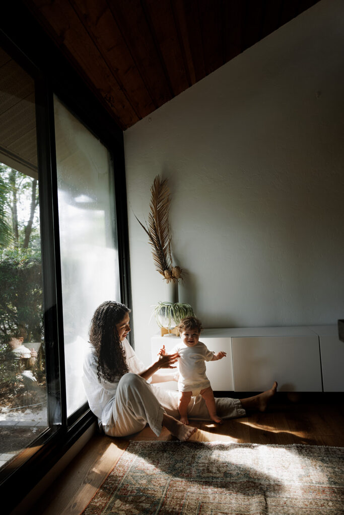 mom and baby sitting down in the dining room in their jacksonville home 