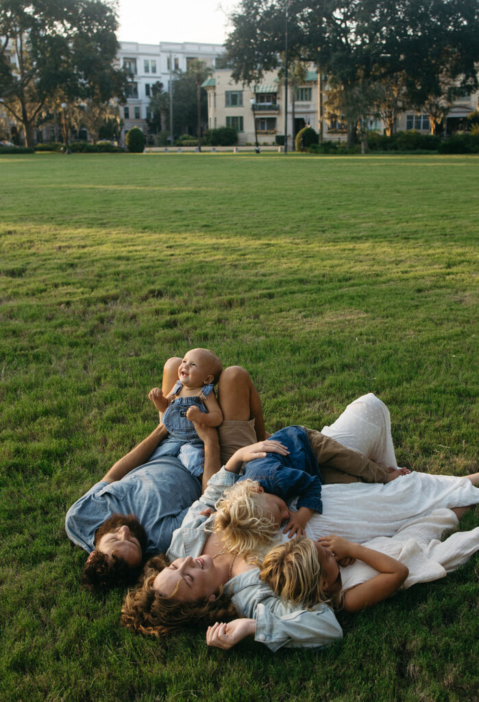 family laying in the grass at memorial park in jacksonville fl