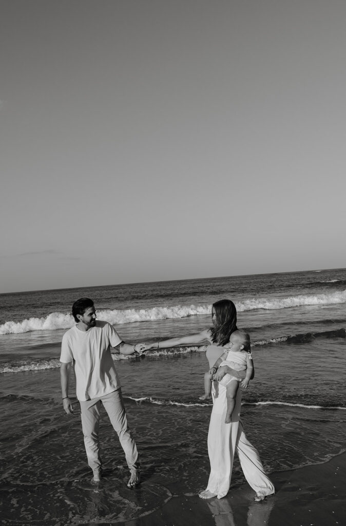 family walking through the water at a jacksonville beach