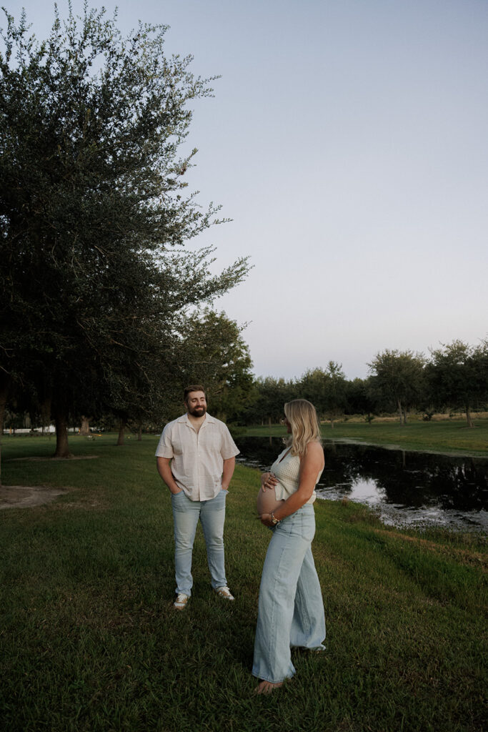 couple posing for their maternity photos at one of the best places for family photos in jacksonville fl 