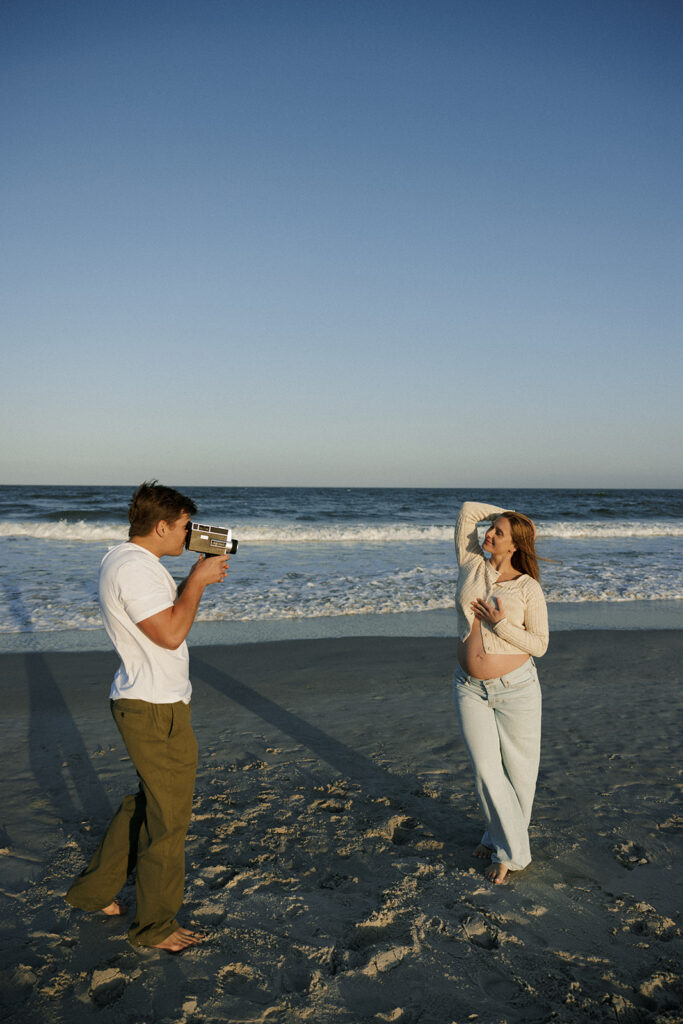 expecting couple posing for beach maternity photography